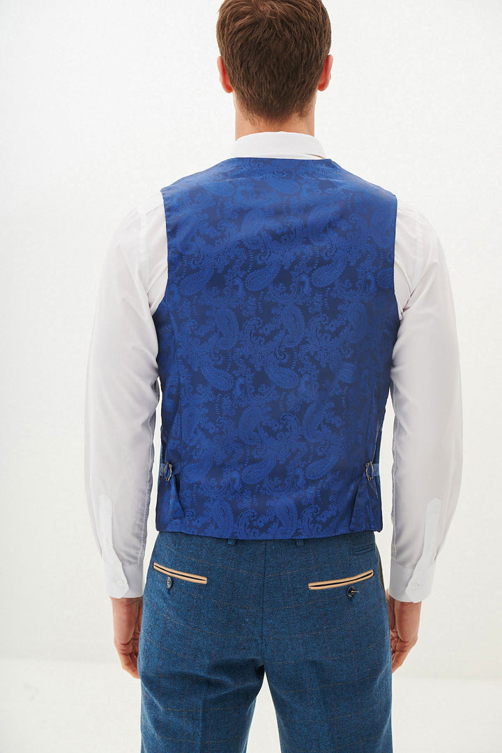 A man is shown from the back in a marcdarcy DION Blue Tweed Check Three Piece Suit, featuring a white dress shirt and blue trousers with tan zippered pockets, set against a plain white background.